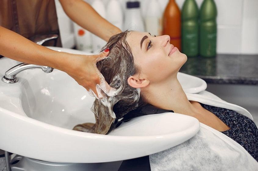 A woman is shampooing hair