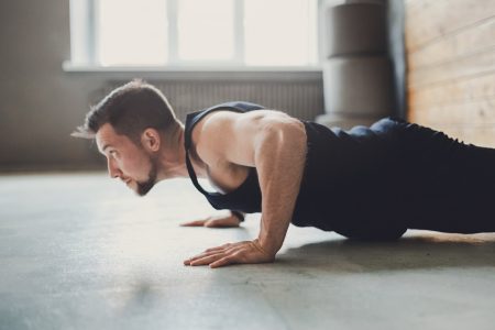 Young man workout in fitness club