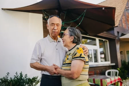 old man & woman holding hands