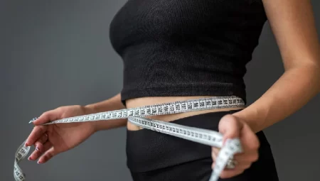 A woman measuring her waist