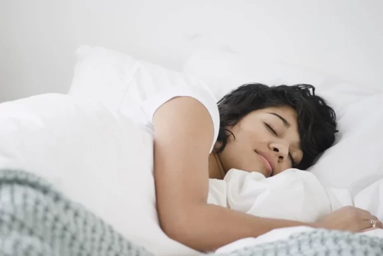 A lady is peacefully sleeping on a comfortable bed, representing the importance of sleep quality and the use of ResMed AirSense 10 for better sleep