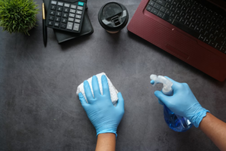 Professional commercial cleaning team disinfecting office surfaces in a modern workspace.