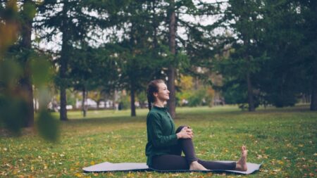 Person practicing healthy habits like exercise, balanced diet, and mindfulness to improve both mental and physical health.