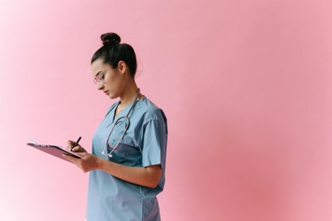 Adult student studying nursing books and preparing for a career change into healthcare as a registered nurse.