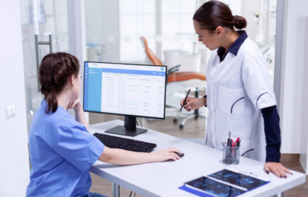 How Medical Practice Management Software Is Transforming Healthcare Operations Doctor using healthcare practice management system on computer