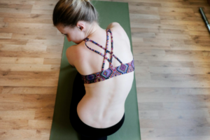 Woman performing neck stretching exercises to relieve neck pain and improve posture for spinal stenosis