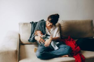 How Breastfeeding Support Benefits Maternal and Infant Health New mother breastfeeding her baby with support from a lactation consultant