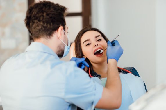 An anxious dental patient with a friendly dentist in a modern dental clinic during treatment