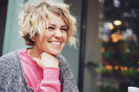 7 Tips to Help Women Stay Healthy Over Time Smiling healthy woman practicing healthy lifestyle habits including hydration, fitness, sleep, and self-care for overall wellness